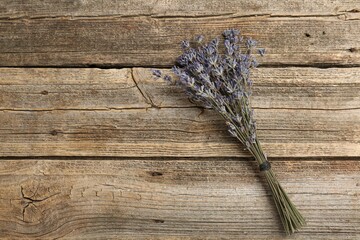 Bunch of aromatic lavender flowers on wooden table, top view. Space for text