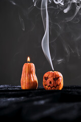 Halloween-style candles on a dark background. Festive decor.