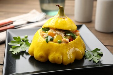 Tasty stuffed pattypan squash on wooden table, closeup