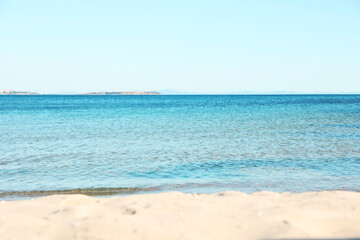 Beautiful sea and sandy beach under light blue sky