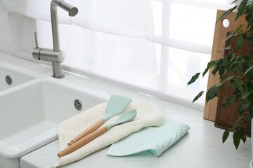 Clean utensils drying on waffle towels in kitchen