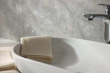 Clean waffle towels near sink in bathroom, closeup