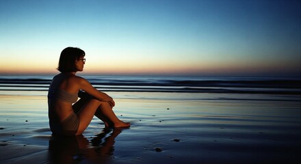 Silhouette of a young woman with short hair sitting on a wet beach at sunset, enjoying the tranquil scenery, wearing glasses and a swimsuit, with soft lighting and reflections on the water .