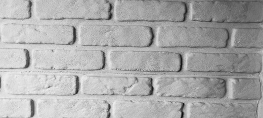 dark wall made of old paving stones, background made of black stone