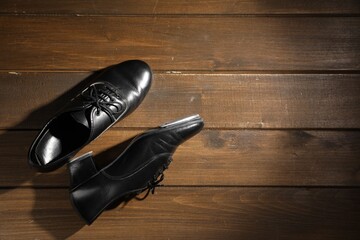 Pair of shoes for tap dance on wooden floor, top view. Space for text