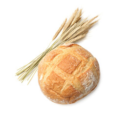 Loaf of fresh bread and spikes isolated on white, top view