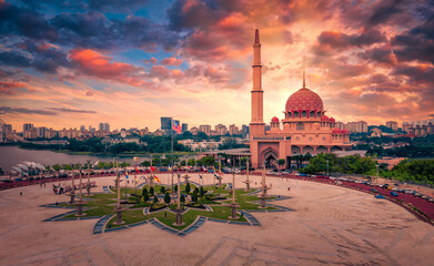 Aerial View Of Putra Mosque with Putrajaya City Centre with Lake at sunset in Putrajaya, Malaysia.