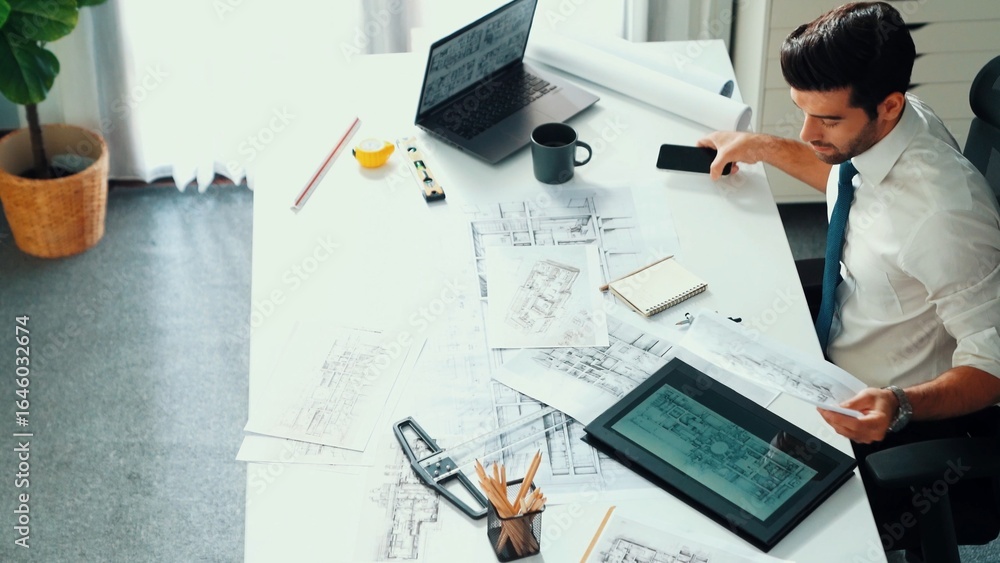 Poster architect engineer using laptop planning house design at office while sitting at meeting table with 