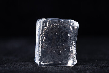 Clear ice cube on black background