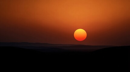 Orange sunset over dark landscape 
