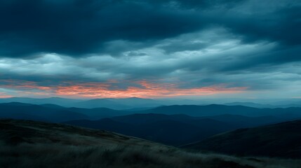 Majestic Mountain Range Under Dramatic Sunset Sky with Clouds