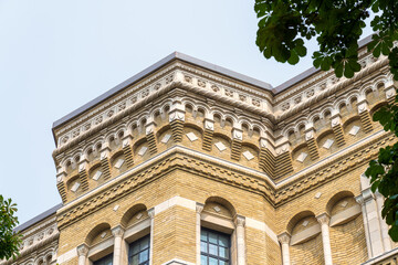 Detailed view of a colonial-style building with ornate stonework and yellow brick near the Royal Ontario Museum.