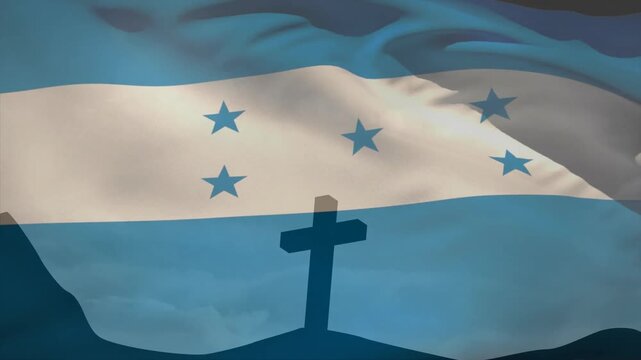 Light breeze sending blue-white-blue flag with five stars waving above cross showing flag motion