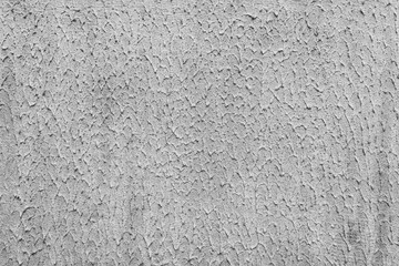 Uneven, old plaster on a concrete wall.