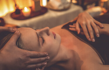 Caucasian woman enjoying relaxing anti-stress head massage and pampering facial beauty skin...