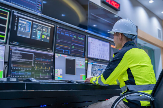 Engineer working at control room, Manager control system, Technician man monitoring program from a lot of monitor.
Specialist observes analytics dashboard,operator inspects digital interface