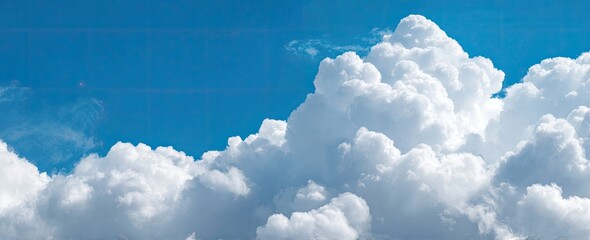 Fluffy clouds against a vibrant blue sky
