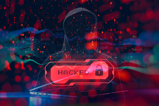 Concept of cyber attack and data breach. Anonymous hacker in hoodie using a laptop with digital binary code overlay, red warning alert with Hacked text, and futuristic interface elements. - Powered by Adobe