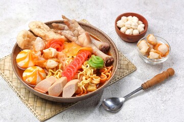 Seblak is a spicy culinary dish from West Java containing crackers, noodle, and chiscken feet with the main spice kencur.