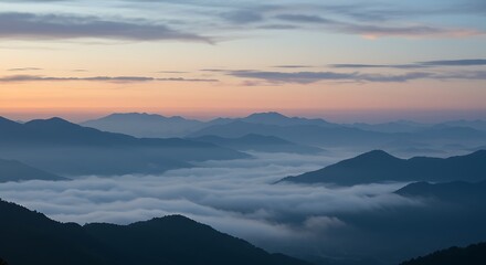 Obraz premium Misty mountain horizon at dawn, cool blue and gray tones, serene backdrop