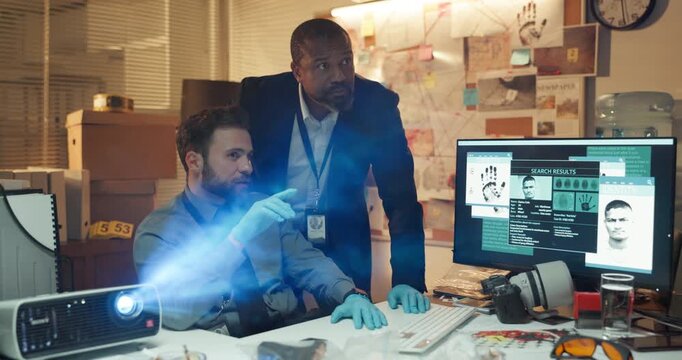 Police man, investigation and team with talk at office, project and search for criminal network with computer. Person, detective and partner with presentation, evidence and strategy with intel lead