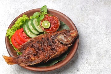 Ikan Nila Bakar. Grilled tilapia fish is a variation of grilled fish that uses tilapia as the main ingredient