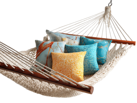 Stylish woven rope hammock with wooden spreader bars and a collection of colorful decorative pillows.