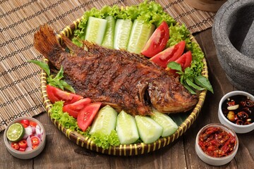 Ikan Nila Bakar. Grilled tilapia fish is a variation of grilled fish that uses tilapia as the main ingredient