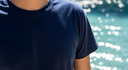 Man wearing a navy blue t-shirt near the water