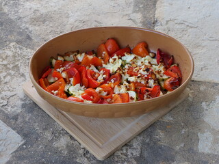 Healthy baked vegetables, consists mainly of roasted vegetables such as red peppers and zucchini sprinkled with feta cheese.