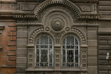 Yerevan, Armenia,   close-up of an ornate historic building facade with two arched windows,...