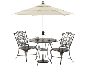Ornate cast aluminum patio bistro set with two chairs a round table and a large cream umbrella for outdoor dining.