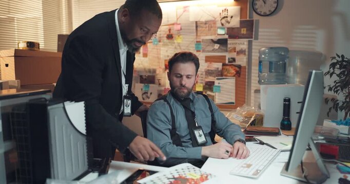 Paperwork, computer and detectives in office with meeting for solving case in collaboration. Documents, team and male private investigators with discussion for briefing on investigation in workplace.