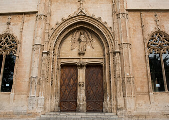 Historic church entrance featuring ornate stonework and wooden doors, showcasing intricate...
