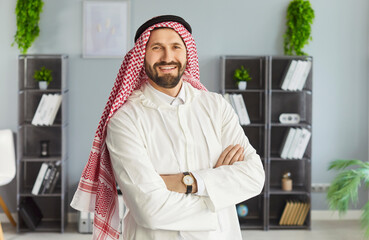 Portrait of successful Arabic businessman dressed in traditional Middle Eastern attire, white thobe...