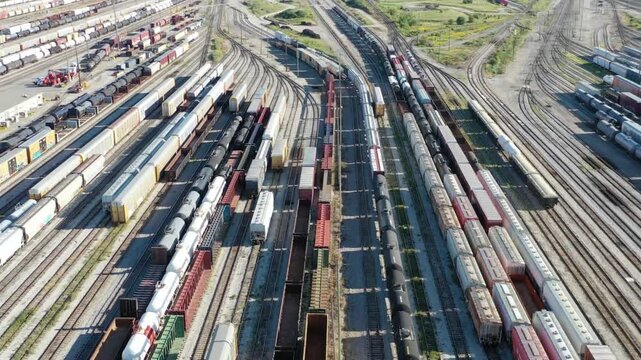 Aerial view of a vast railroad yard with numerous tracks and freight cars