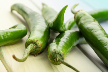 green hot chili pepper on wood background