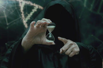 A mysterious figure in a black cloak holds an hourglass against a background of an abstract DNA...