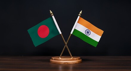 Bangladesh and India flags crossed on a desk, representing partnership