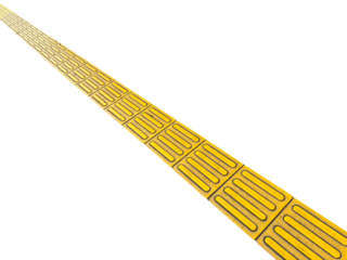 yellow tactile paving path for the blind and visually impaired. The textured surface provides guidance and safety on the street.