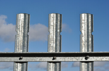 Steel Security Fence seen in Close Up against Blue Sky 