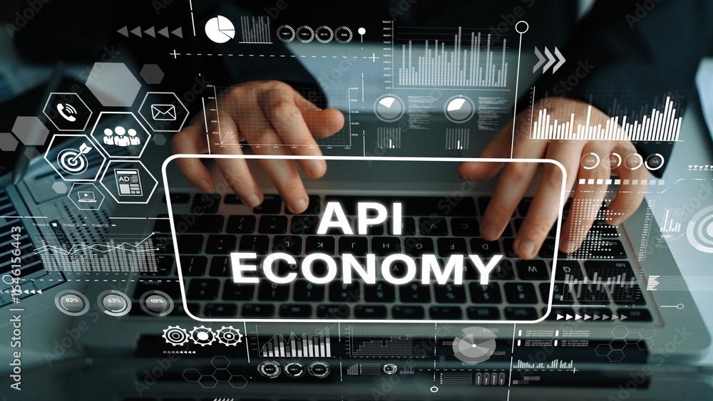 Poster hands typing on laptop with overlaid graphics representing the concept of api economy in digital tra