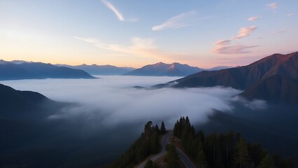 Misty mountain valley at sunrise with fog rolling through the peaks and trees