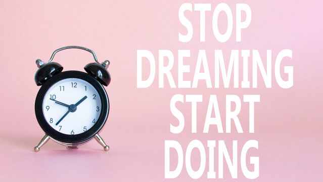 Naklejki Stop Dreaming Start Doing symbol. Beautiful pink background with alarm clock. Business and Stop Dreaming Start Doing concept. Copy space.