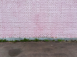 Old brick pink wall and asphalt floor