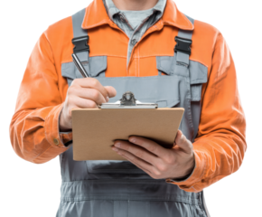 A worker in orange overalls meticulously takes notes on a clipboard