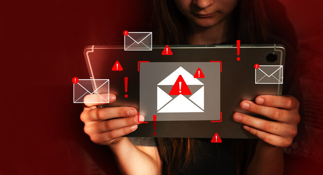 A teenage girl holding tablet with warning email icons, phishing attack, malware, data breach, cybersecurity alert, scam message and spam risk. Warning and danger.
