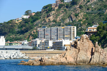 View towards Blanes port with rock on foreground, Catalonia, Spain.