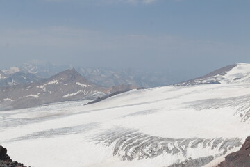 Obraz premium The cracked Bolshoy Azau glacier on the slopes of Elbrus in midsummer