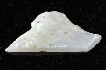 sample of rough white nephrite mineral on black